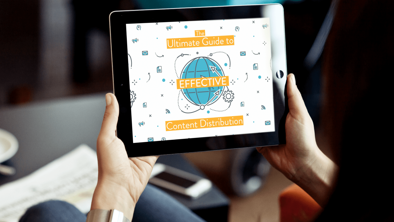 The Ultimate Guide to Effective Content Distribution. Image contents: Two hands holding an iPad with the whitepaper on the screen.